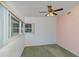 Simple bedroom with ceiling fan, carpet, and window at 3107 S Park Ave, Sanford, FL 32773