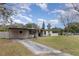 Ranch style home with carport and a large grassy yard at 3107 S Park Ave, Sanford, FL 32773