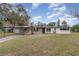 Ranch style home with carport, mature landscaping, and spacious yard at 3107 S Park Ave, Sanford, FL 32773