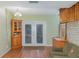 Living room with wood floors, built-ins, and French doors at 3107 S Park Ave, Sanford, FL 32773