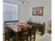 Dining room with a large wooden table and six chairs, along with a serving table at 3333 Wauseon Dr, Saint Cloud, FL 34772