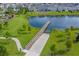 Wooden dock extending into a calm lake with lush greenery at 3333 Wauseon Dr, Saint Cloud, FL 34772