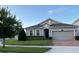 One-story house with gray siding, a two-car garage, and a well-manicured lawn at 3333 Wauseon Dr, Saint Cloud, FL 34772