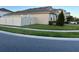 Side view of a house with a gray exterior, white vinyl fence, and neatly trimmed lawn at 3333 Wauseon Dr, Saint Cloud, FL 34772