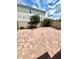 View of a backyard with brick pavers, tree line, and privacy fence at 3333 Wauseon Dr, St Cloud, FL 34772