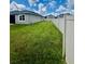 Spacious backyard featuring a lush green lawn and a secure white fence at 3333 Wauseon Dr, St Cloud, FL 34772