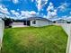 This backyard features a spacious lawn area, patio, and screened-in porch for outdoor enjoyment at 3333 Wauseon Dr, St Cloud, FL 34772