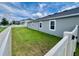 Home exterior showcasing a lush green lawn and white fence providing privacy at 3333 Wauseon Dr, St Cloud, FL 34772