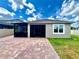 Brick patio, screened-in porch, and green lawn create a perfect outdoor retreat at 3333 Wauseon Dr, St Cloud, FL 34772