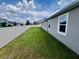 Lush green backyard with a pristine white fence offers a serene and private outdoor space at 3333 Wauseon Dr, St Cloud, FL 34772