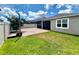 Backyard featuring a well-maintained lawn, brick patio, and screened-in porch perfect for outdoor entertaining at 3333 Wauseon Dr, St Cloud, FL 34772