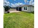 Backyard featuring a well-maintained lawn, brick patio, and screened-in porch perfect for outdoor entertaining at 3333 Wauseon Dr, St Cloud, FL 34772