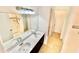 Bright bathroom featuring double sinks, a large mirror and updated tiling at 3333 Wauseon Dr, St Cloud, FL 34772