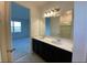 A bright bathroom featuring double sinks, a large mirror and tile accents at 3333 Wauseon Dr, St Cloud, FL 34772