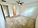 Carpeted bedroom offers a blank canvas with neutral walls, ceiling fan and connecting bathroom at 3333 Wauseon Dr, St Cloud, FL 34772