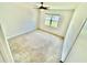 Bright bedroom features plush carpet, a ceiling fan, and a window providing natural light at 3333 Wauseon Dr, St Cloud, FL 34772
