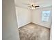 Neutral bedroom with a ceiling fan and a window letting in natural light at 3333 Wauseon Dr, St Cloud, FL 34772
