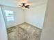 This bedroom has neutral carpet, one window, and a ceiling fan at 3333 Wauseon Dr, St Cloud, FL 34772