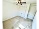Neutral bedroom with carpet, fresh white walls, a ceiling fan and a closet with double doors at 3333 Wauseon Dr, St Cloud, FL 34772