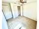 Neutral bedroom with carpet, fresh white walls, a ceiling fan and a closet with double doors at 3333 Wauseon Dr, St Cloud, FL 34772