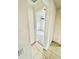 Hallway peek into a bright bedroom with a ceiling fan, neutral walls and carpet at 3333 Wauseon Dr, St Cloud, FL 34772