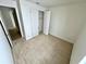 Bright bedroom featuring neutral carpet and a closet with sliding doors at 3333 Wauseon Dr, St Cloud, FL 34772