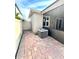 Exterior of the home shows the back patio with brick pavers and access gate to side yard at 3333 Wauseon Dr, St Cloud, FL 34772