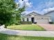 Beautiful single-story home with lush lawn, manicured shrubs, and attached garage at 3333 Wauseon Dr, St Cloud, FL 34772