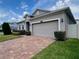 Well maintained home with a brick paver driveway, mature landscaping and a two car garage at 3333 Wauseon Dr, St Cloud, FL 34772