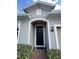 Charming front entryway with a dark front door, welcome mat and manicured landscaping at 3333 Wauseon Dr, St Cloud, FL 34772