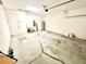 Open two-car garage with utility equipment and cracked concrete floor at 3333 Wauseon Dr, St Cloud, FL 34772