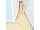 Bright hallway features neutral tile flooring and fresh white walls, leading to other rooms of the home at 3333 Wauseon Dr, St Cloud, FL 34772