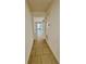 Hallway with neutral floor tile leading to the main living area and screened in porch at 3333 Wauseon Dr, St Cloud, FL 34772