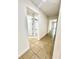 Hallway leading to bathroom and bedroom with neutral tile flooring at 3333 Wauseon Dr, St Cloud, FL 34772