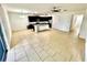 Bright, open-concept kitchen features tile flooring, an island, and dark cabinetry for a modern aesthetic at 3333 Wauseon Dr, St Cloud, FL 34772