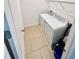 Convenient laundry room features a washer and dryer with overhead shelving for storage at 3333 Wauseon Dr, St Cloud, FL 34772