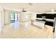 Open-concept living space with tile flooring, a modern kitchen and sliding glass doors to outdoor space at 3333 Wauseon Dr, St Cloud, FL 34772
