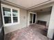 Covered patio with brick pavers, window, and sliding glass door access to the interior at 3333 Wauseon Dr, St Cloud, FL 34772
