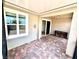Enclosed patio with brick floor and wall window offering a cozy space at 3333 Wauseon Dr, St Cloud, FL 34772