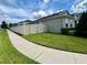 Home featuring a well-manicured lawn, and a clean sidewalk at 3333 Wauseon Dr, St Cloud, FL 34772