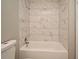 Updated bathroom with marble-look tile shower/tub combo at 3362 Janet St, Apopka, FL 32712