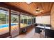 Screened porch with wood ceiling and view of pool at 3425 Suzette Dr, Kissimmee, FL 34746