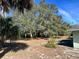 Large backyard with mature trees and shrubs at 3457 Seminole St, Gotha, FL 34734