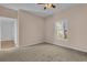 Well-lit bedroom featuring neutral walls and carpet at 3593 Conroy Rd # 413, Orlando, FL 32839