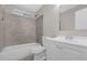 Clean bathroom with white vanity, toilet and shower/tub combo at 3650 Se 140Th Pl, Summerfield, FL 34491