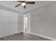 Bedroom with double doors leading to another room and grey flooring at 3650 Se 140Th Pl, Summerfield, FL 34491