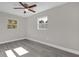 Well-lit bedroom featuring wood-look floors and a ceiling fan at 3650 Se 140Th Pl, Summerfield, FL 34491