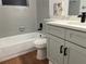 Renovated bathroom with gray vanity, white quartz countertop, and a white bathtub at 407 Parson Brown Way, Longwood, FL 32750