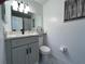 Gray vanity, white quartz countertop, and updated toilet in a small bathroom at 407 Parson Brown Way, Longwood, FL 32750