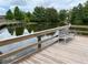 Serene waterfront dock with a bench overlooking a peaceful lake at 407 Parson Brown Way, Longwood, FL 32750